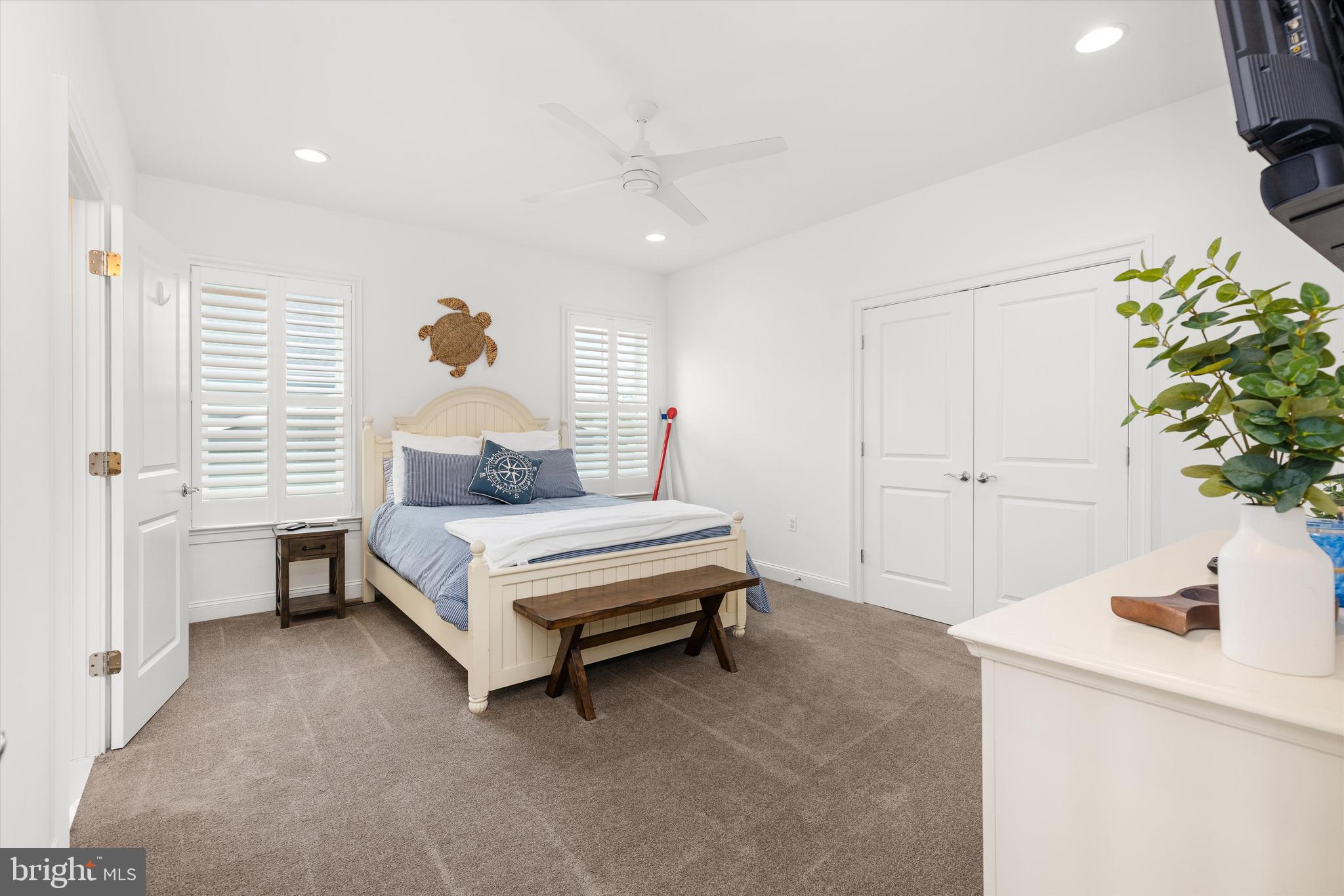 10119 Fast Colors Lane Berlin, MD 21811 - Photo 39 of 43 a bedroom with a bed and a potted plant