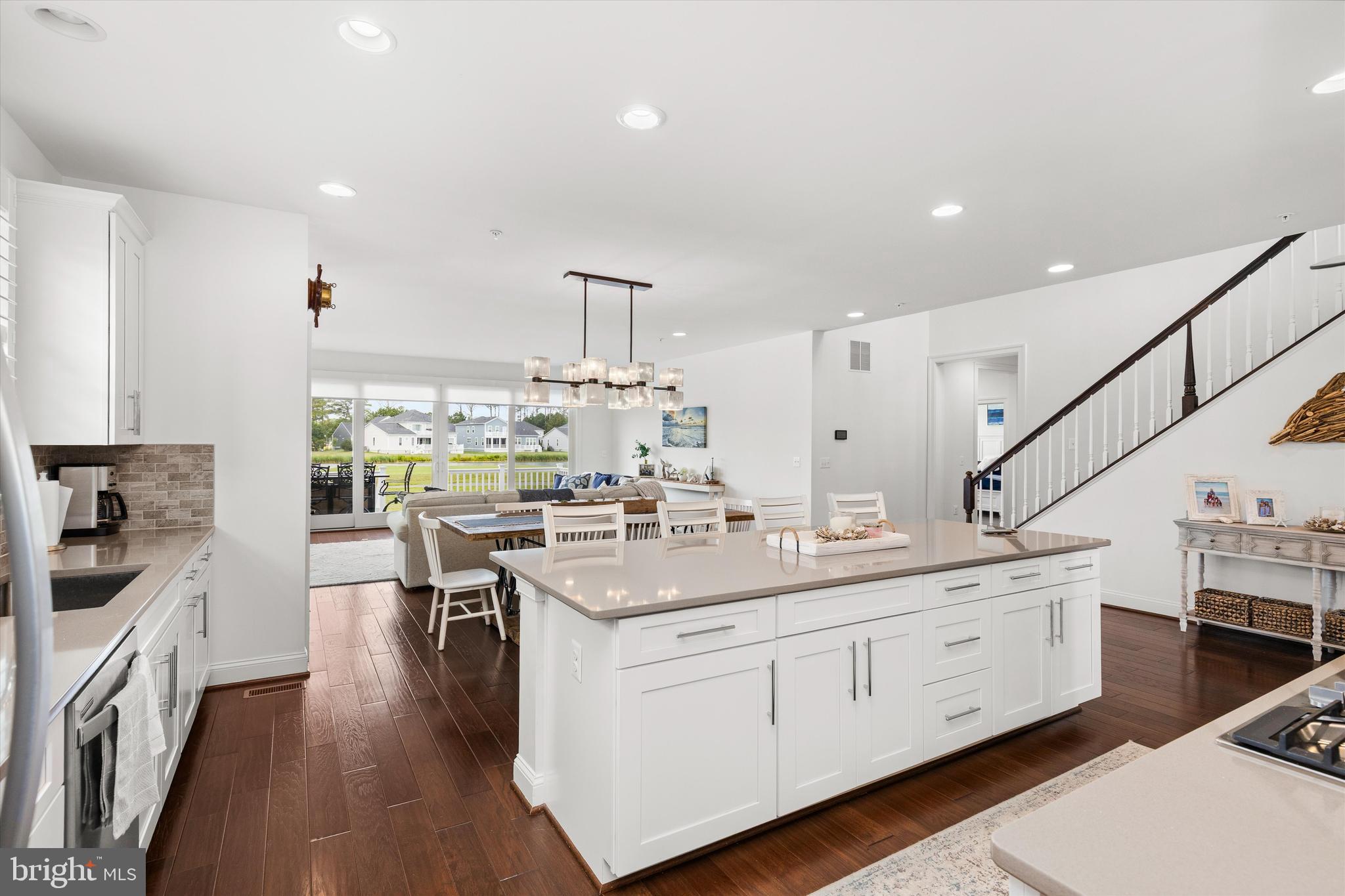 10119 Fast Colors Lane Berlin, MD 21811 - Photo 7 of 43 a kitchen with a sink a counter top space stainless steel appliances and cabinets