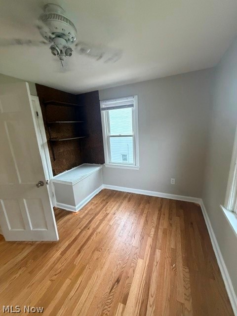 1388 Cranover Road Lyndhurst, OH 44124 - Photo 21 of 35 Hardwood flooring, built-in shelving, built-in window bench, ceiling fan, and window with blinds