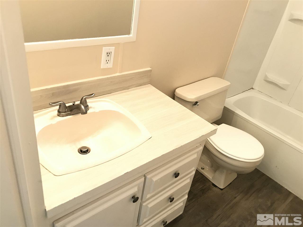 1890 Collins Circle Reno, NV 89506 - Photo 15 of 21 a bathroom with a sink mirror vanity and toilet