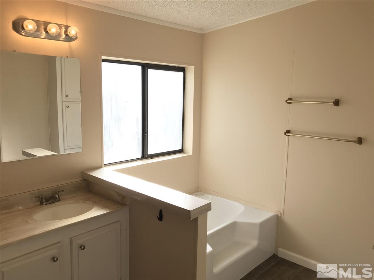 1890 Collins Circle Reno, NV 89506 - Photo 19 of 21 a bathroom with a sink and a mirror