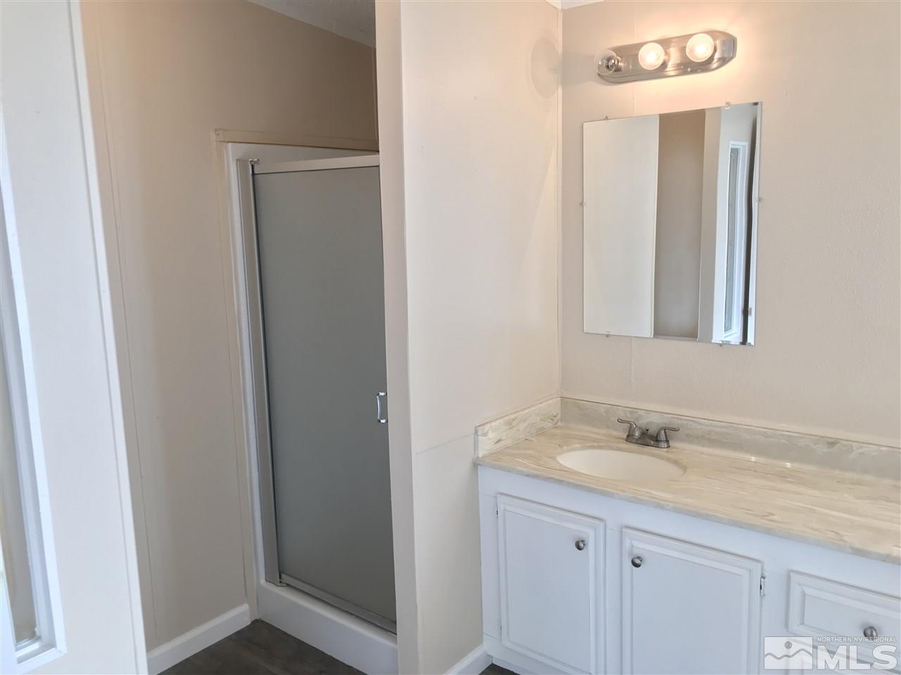 1890 Collins Circle Reno, NV 89506 - Photo 20 of 21 a bathroom with a granite countertop sink and a mirror