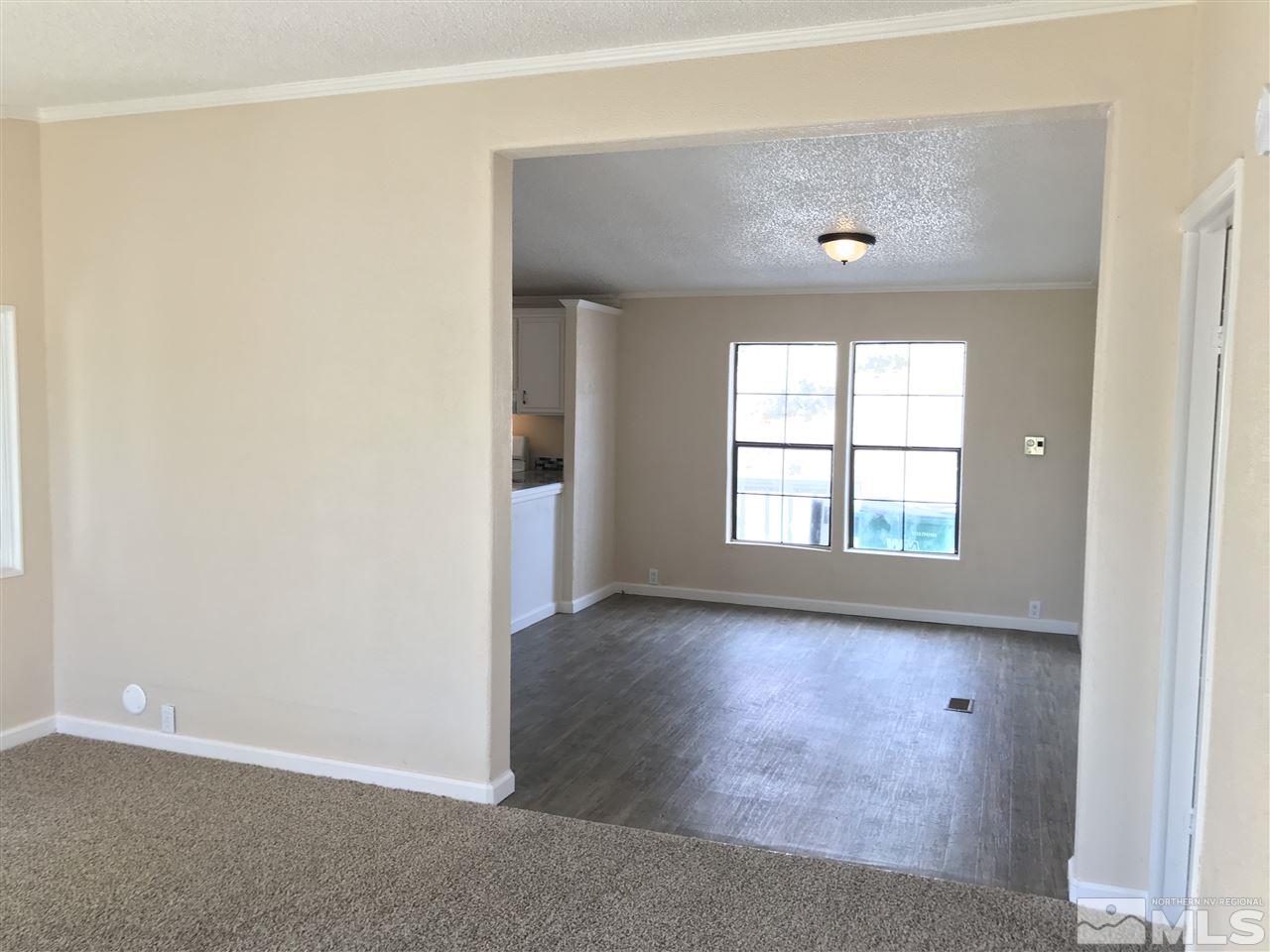 1890 Collins Circle Reno, NV 89506 - Photo 3 of 21 an empty room with wooden floor and windows