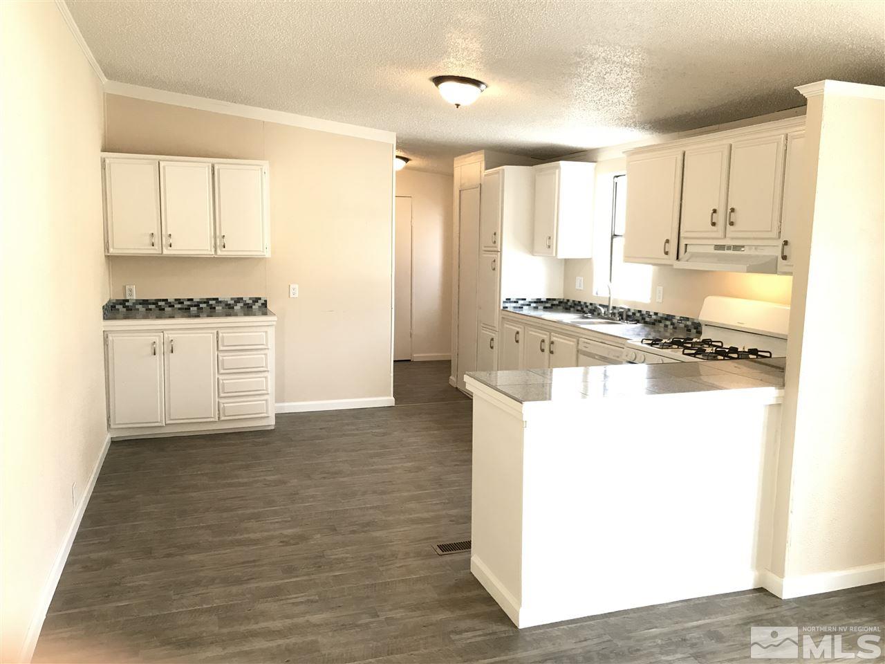 1890 Collins Circle Reno, NV 89506 - Photo 8 of 21 a kitchen with stainless steel appliances granite countertop a stove a sink and a refrigerator