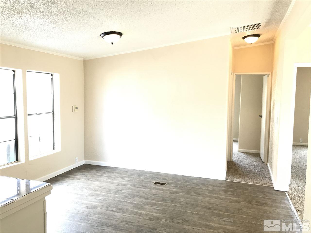 1890 Collins Circle Reno, NV 89506 - Photo 10 of 21 a view of empty room with wooden floor and fan