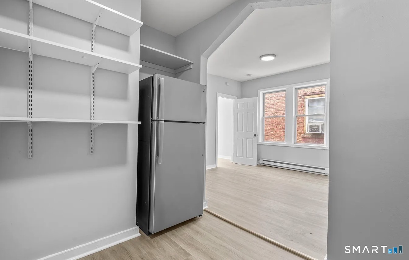25 Whittier Street, Unit 3 Bridgeport, CT 06605 - Photo 5 of 7 a view of a kitchen with a refrigerator and a window