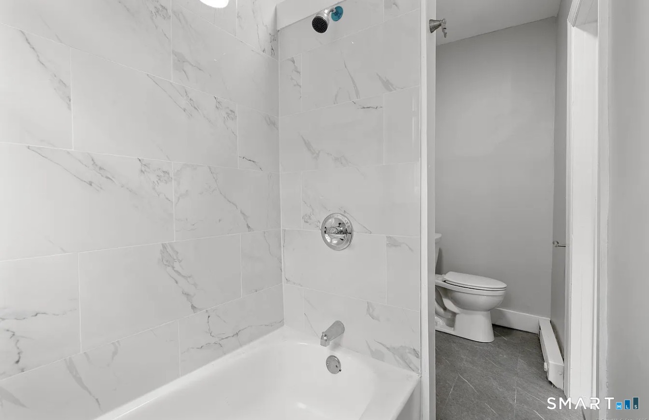 25 Whittier Street, Unit 3 Bridgeport, CT 06605 - Photo 6 of 7 a bathroom with a bathtub and a toilet