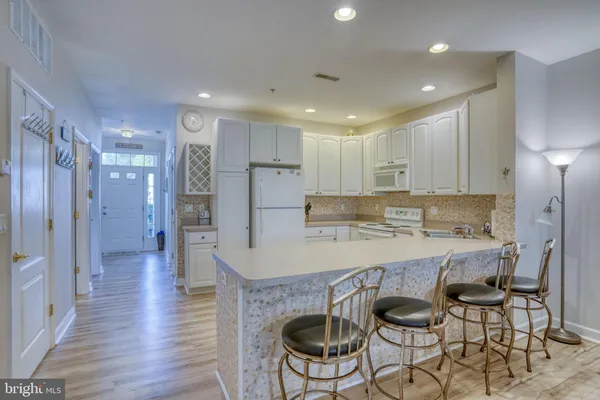 a kitchen with a refrigerator a stove and cabinets