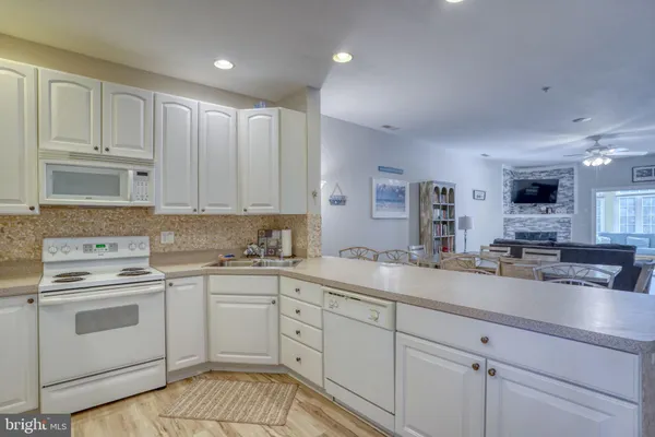 a kitchen with a sink cabinets and wooden floor