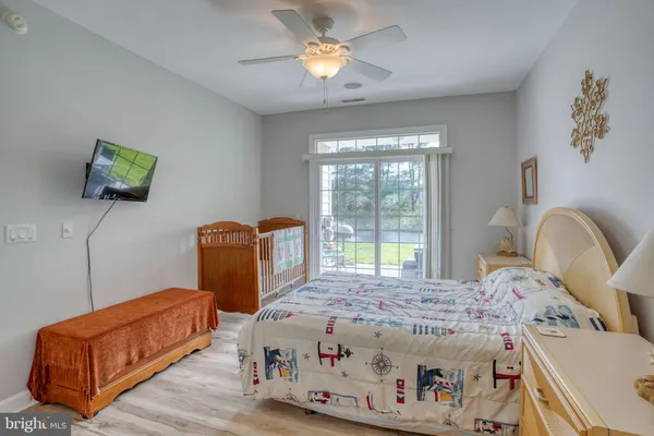 a bedroom with bed and wooden floor