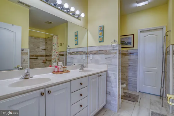 a bathroom with a double vanity sink and a mirror