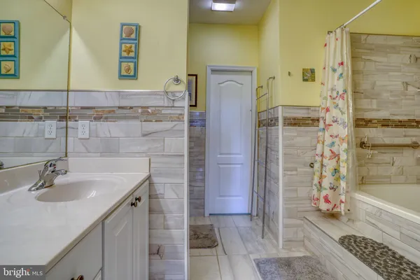 a bathroom with a sink a mirror and shower