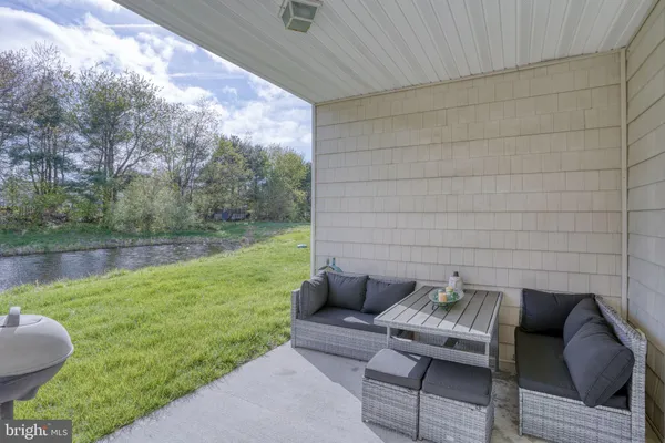 a backyard of a house with table and chairs