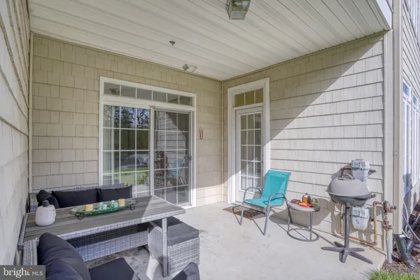 a outdoor living space with patio furniture and potted plants