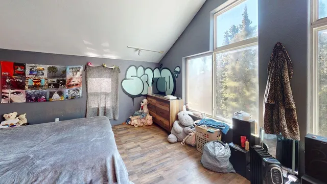 a living room with furniture a window and a flat screen tv