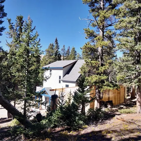 a aerial view of a house with a yard and tree s