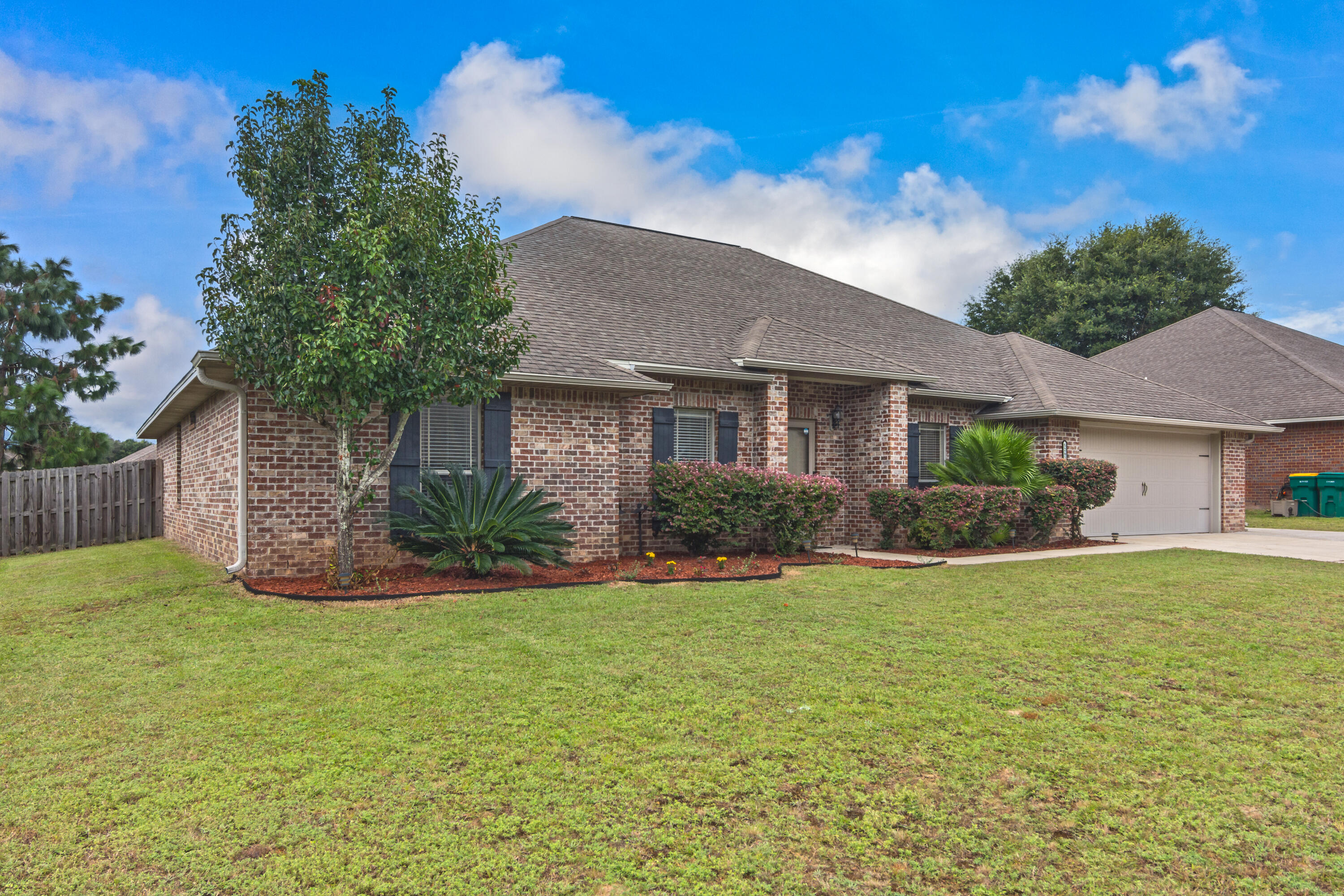 5265 Moore Loop Crestview, FL 32536 - Photo 2 of 43 a view of a house with a yard and a garden