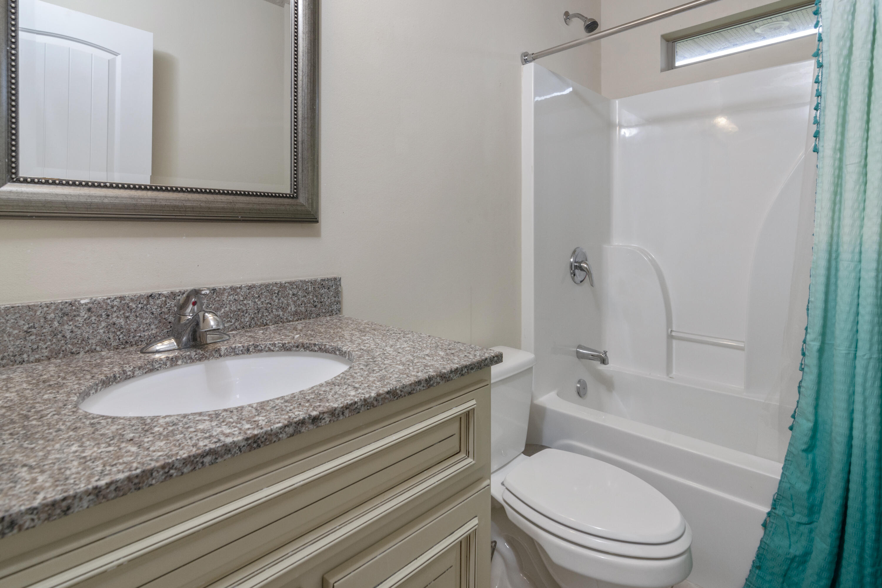 5265 Moore Loop Crestview, FL 32536 - Photo 20 of 43 a bathroom with a granite countertop toilet sink and mirror