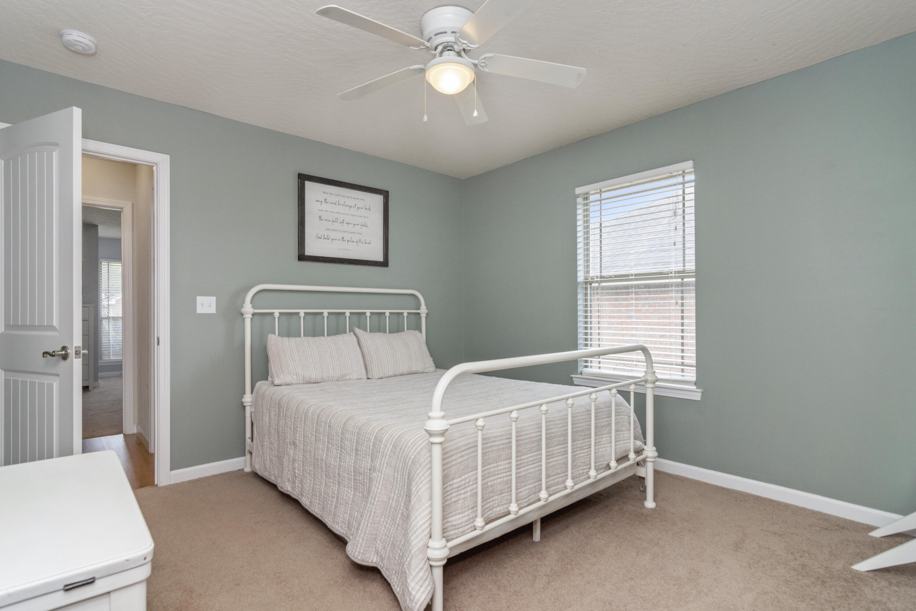 5265 Moore Loop Crestview, FL 32536 - Photo 23 of 43 a bedroom with a bed and a chandelier