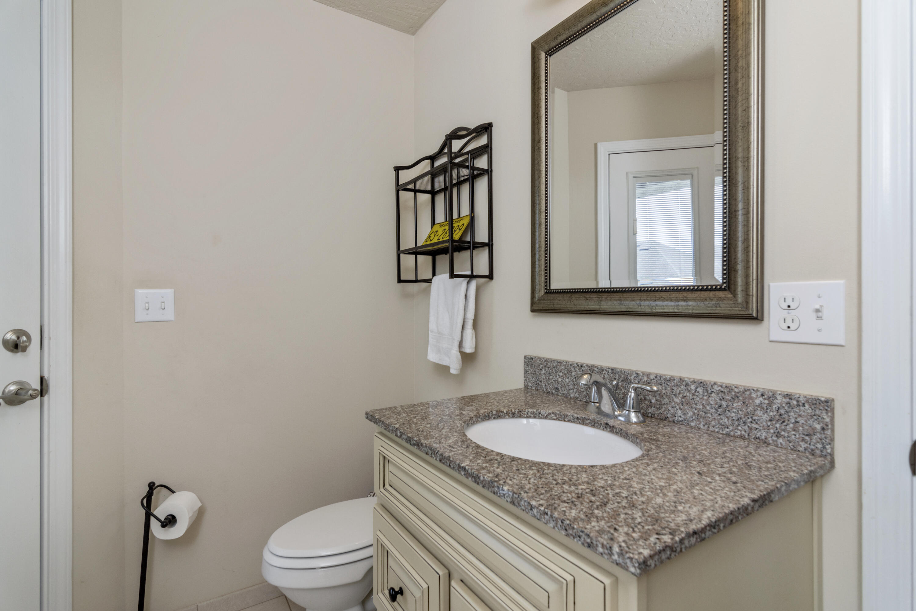 5265 Moore Loop Crestview, FL 32536 - Photo 27 of 43 a bathroom with a granite countertop sink and a mirror