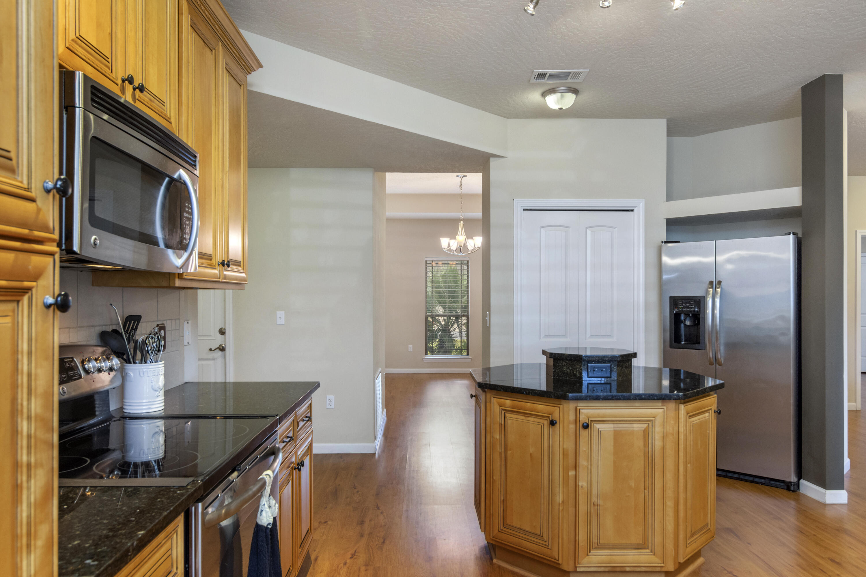 5265 Moore Loop Crestview, FL 32536 - Photo 4 of 43 a kitchen with stainless steel appliances granite countertop a sink a stove and a wooden floors