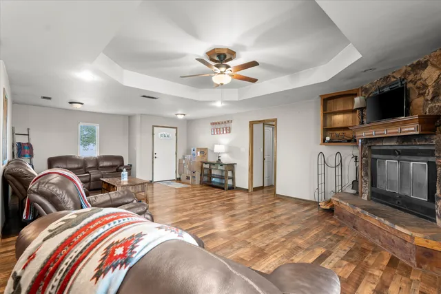 a view of a livingroom with furniture and a ceiling fan