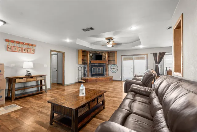 a living room with furniture and a wooden floor