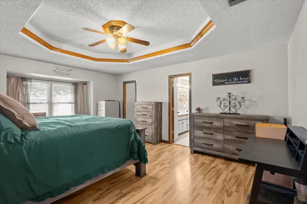 a bedroom with a bed and a chandelier