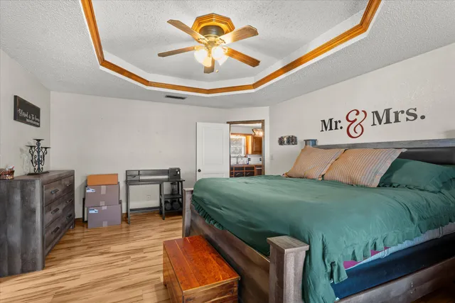 a bedroom with a bed and a chandelier