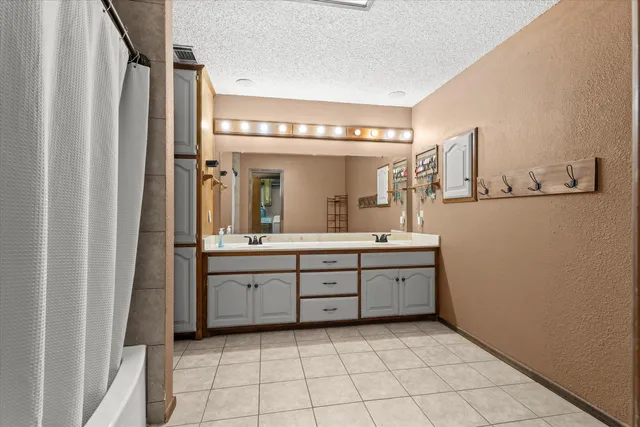 a bathroom with a granite countertop sink mirror and vanity