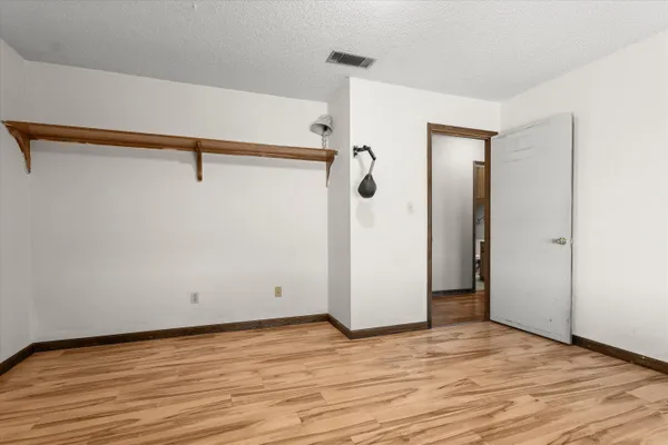 a view of a room with wooden floor and cabinet