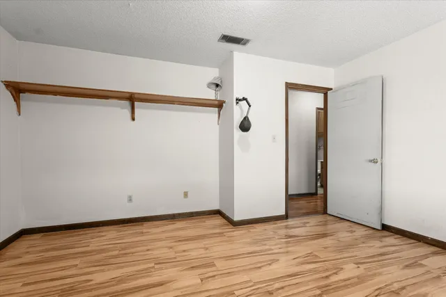 a view of a room with wooden floor and cabinet