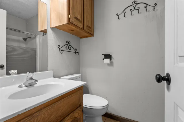a bathroom with a sink toilet and a mirror