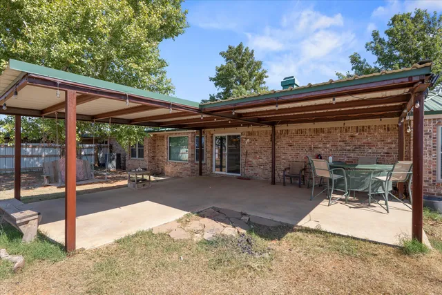 a view of a house with a tree in the background