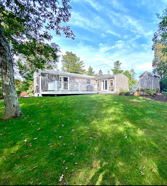 10 Sandpiper Road Harwich, MA 02645 - Photo 7 of 41 a view of a house with a big yard and large trees