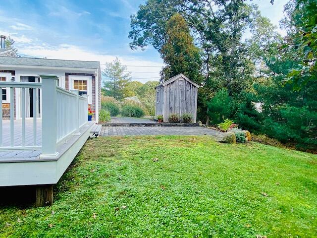 10 Sandpiper Road Harwich, MA 02645 - Photo 8 of 41 a backyard of a house with table and chairs