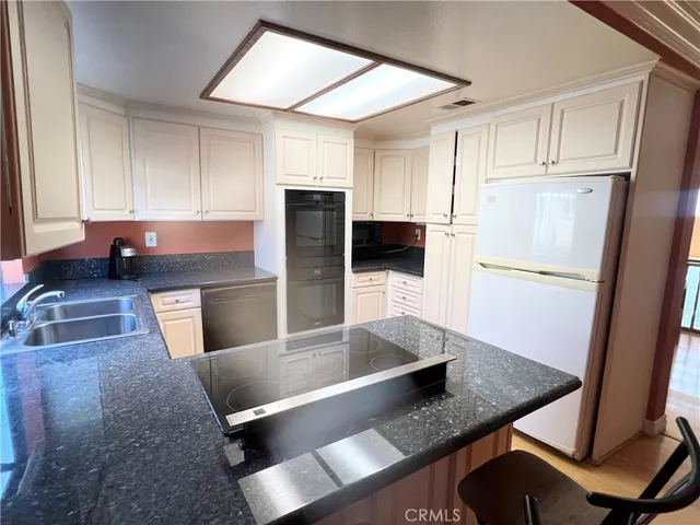 a room with gym equipment and wooden floor