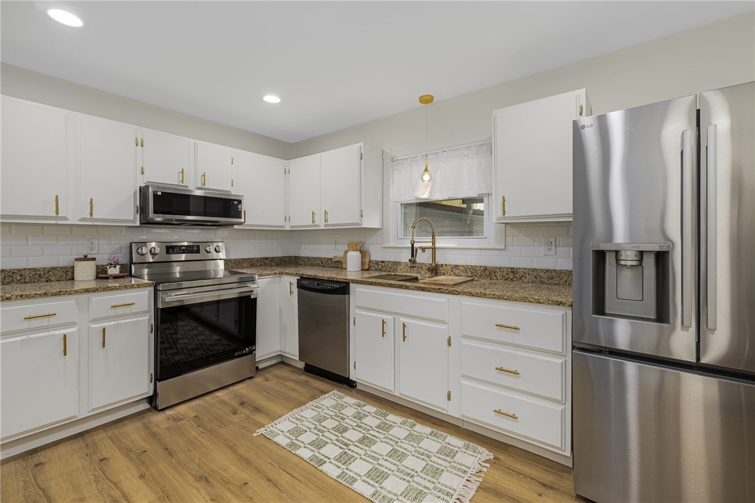461 River Road Lincoln, RI 02865 - Photo 6 of 32 White subway tiled backsplash and recessed lighting