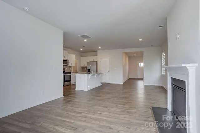 a view of kitchen and hall with wooden floor
