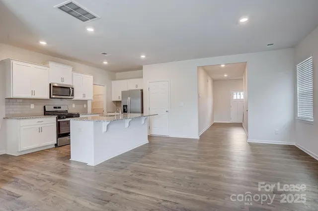 a view of kitchen with sink microwave and refrigerator