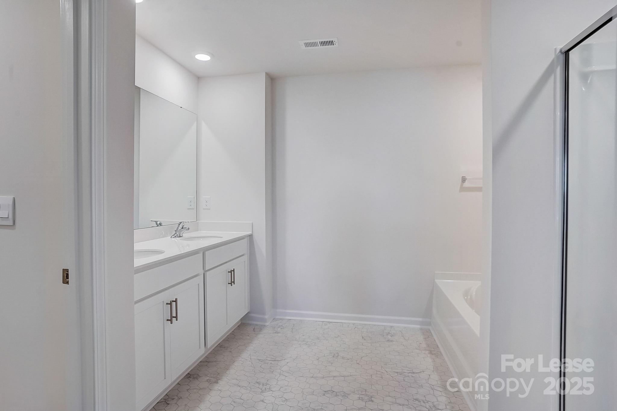 142 Old Home Road Statesville, NC 28677 - Photo 17 of 23 a bathroom with a double vanity sink and mirror