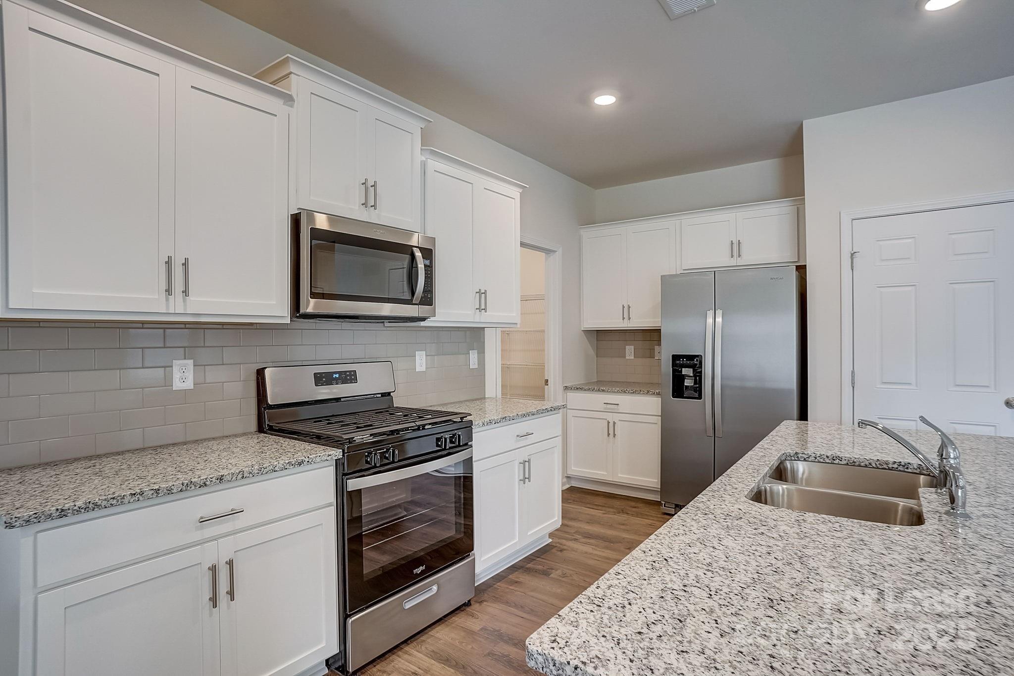 142 Old Home Road Statesville, NC 28677 - Photo 7 of 23 a kitchen with granite countertop a sink stove and refrigerator