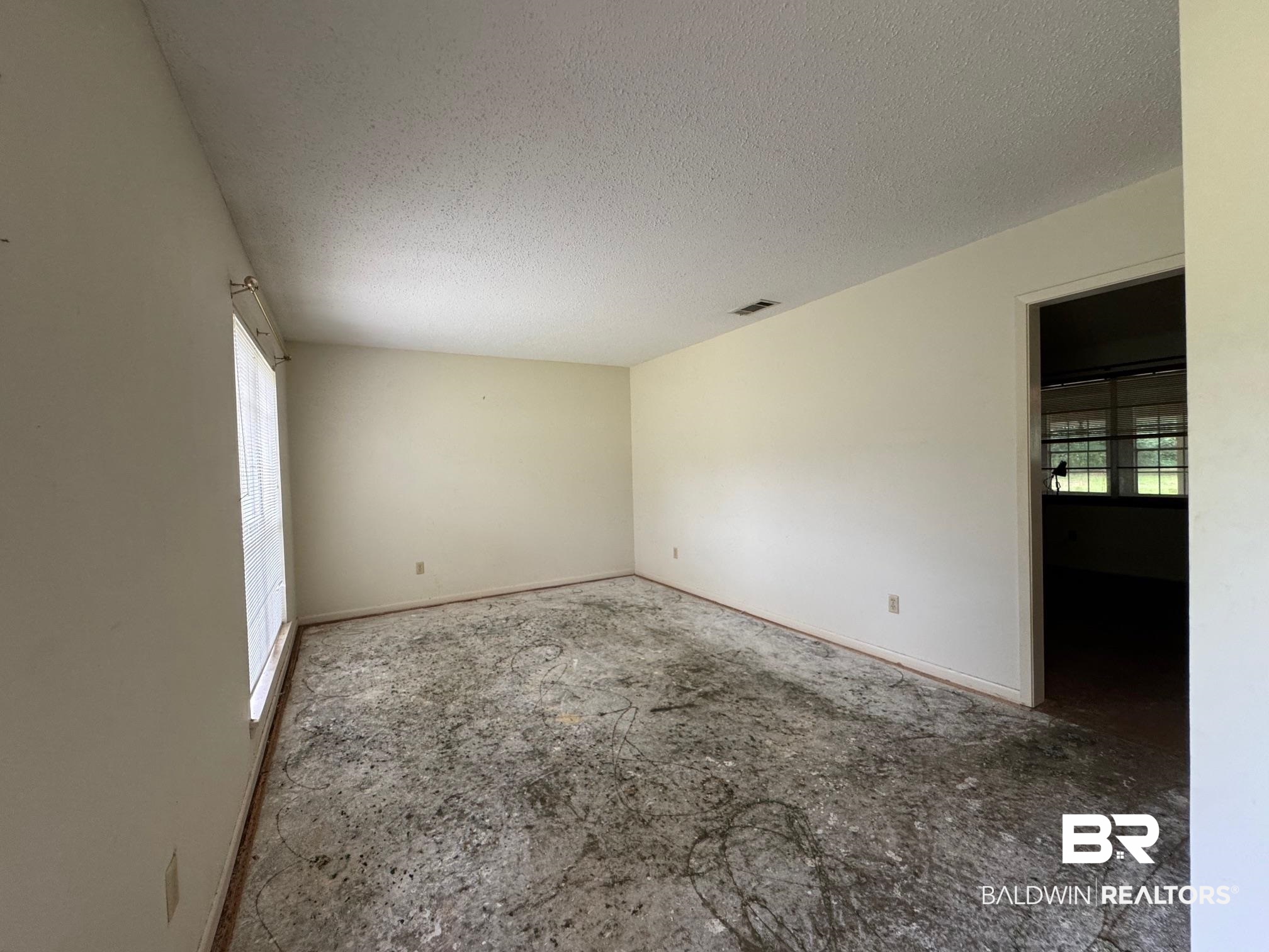 5198 Lancelot Drive Mobile, AL 36619 - Photo 3 of 30 Unfurnished room with a textured ceiling and healthy amount of natural light
