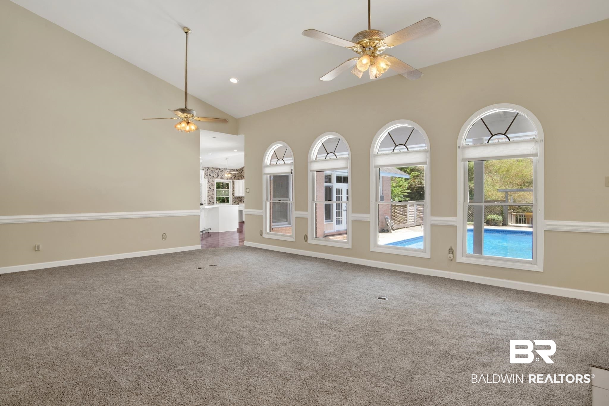6805 Hunters Court Mobile, AL 36695 - Photo 9 of 37 Unfurnished living room with a ceiling fan, carpet floors, baseboards, and high vaulted ceiling