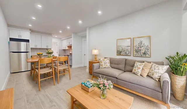 a living room with furniture kitchen view and a dining table
