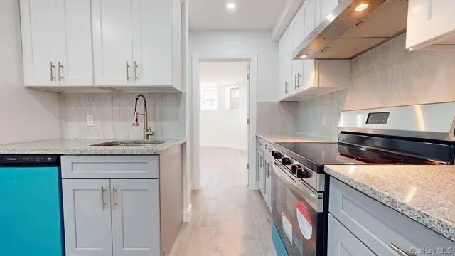 a kitchen with stainless steel appliances granite countertop a stove and a sink