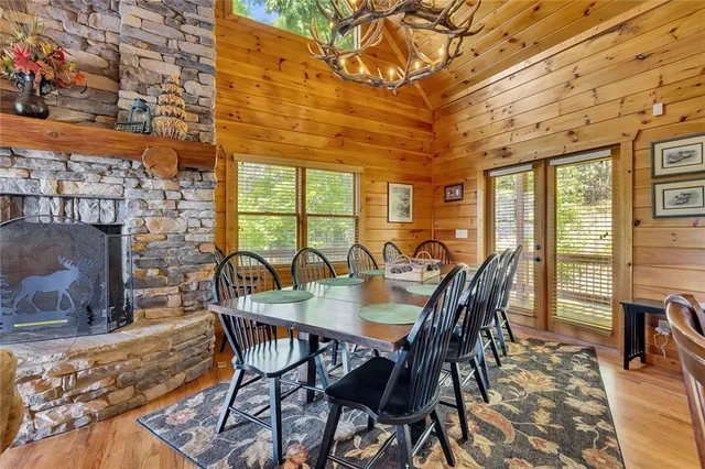 a view of a dining room with furniture a chandelier and wooden floor