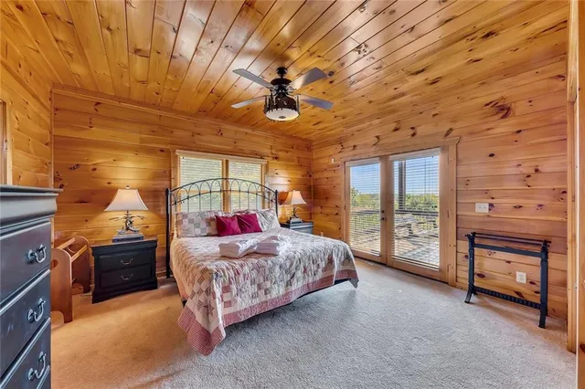 a living room with a bed furniture and a flat tv screen