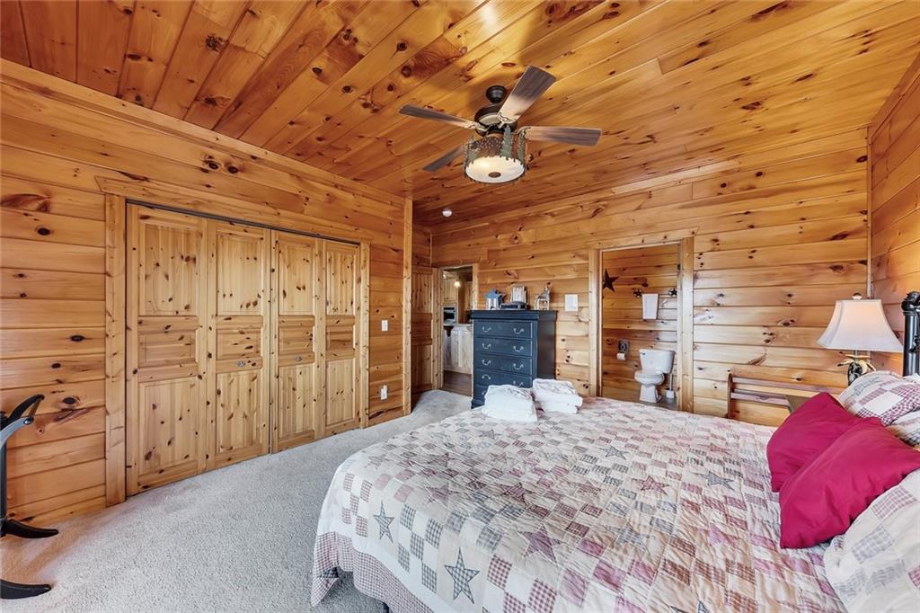 499 Raven Ridge Circle Mineral Bluff, GA 30559 - Photo 14 of 43 a bed room with a bed and a chair