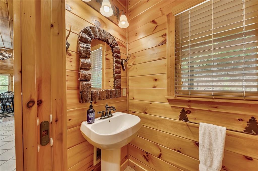 499 Raven Ridge Circle Mineral Bluff, GA 30559 - Photo 16 of 43 a bathroom with a sink and a mirror